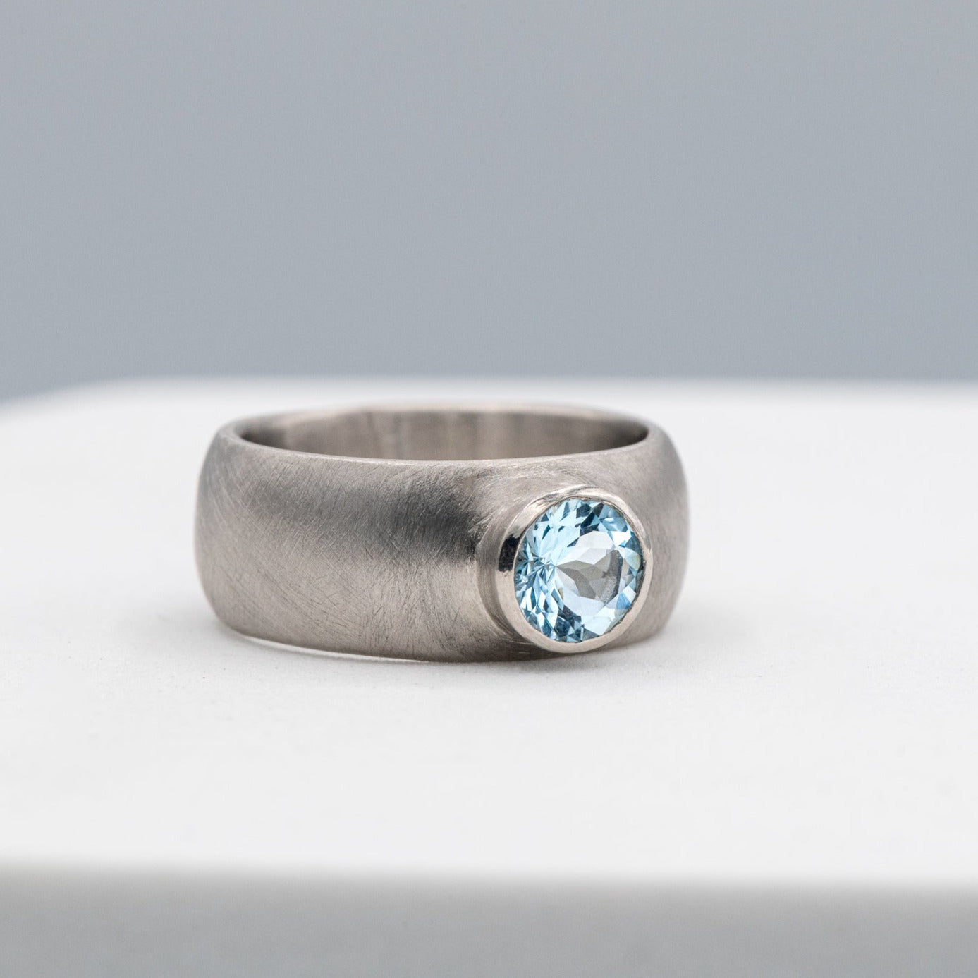 A handmade silver ring with a Chunky White Gold Engagement Ring by Cassin Jewelry.