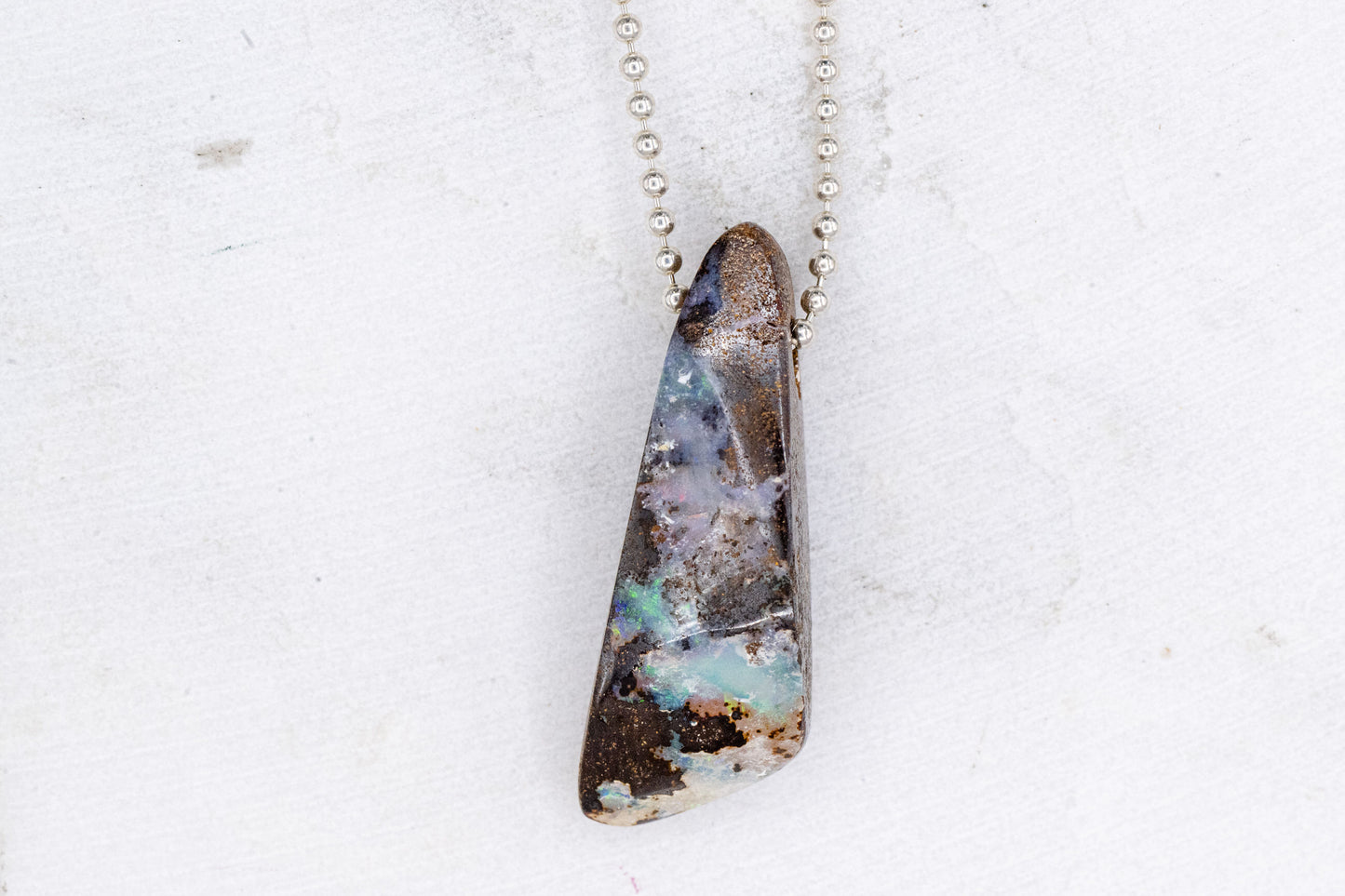 A Handmade Australian Opal Necklace with a piece of opal on it, by Cassin Jewelry.