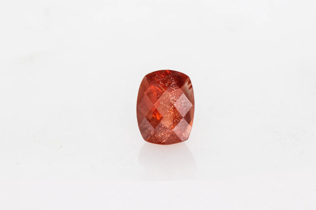 A handmade Custom Cushion Sunstone Ring in Rose Gold on a white background.