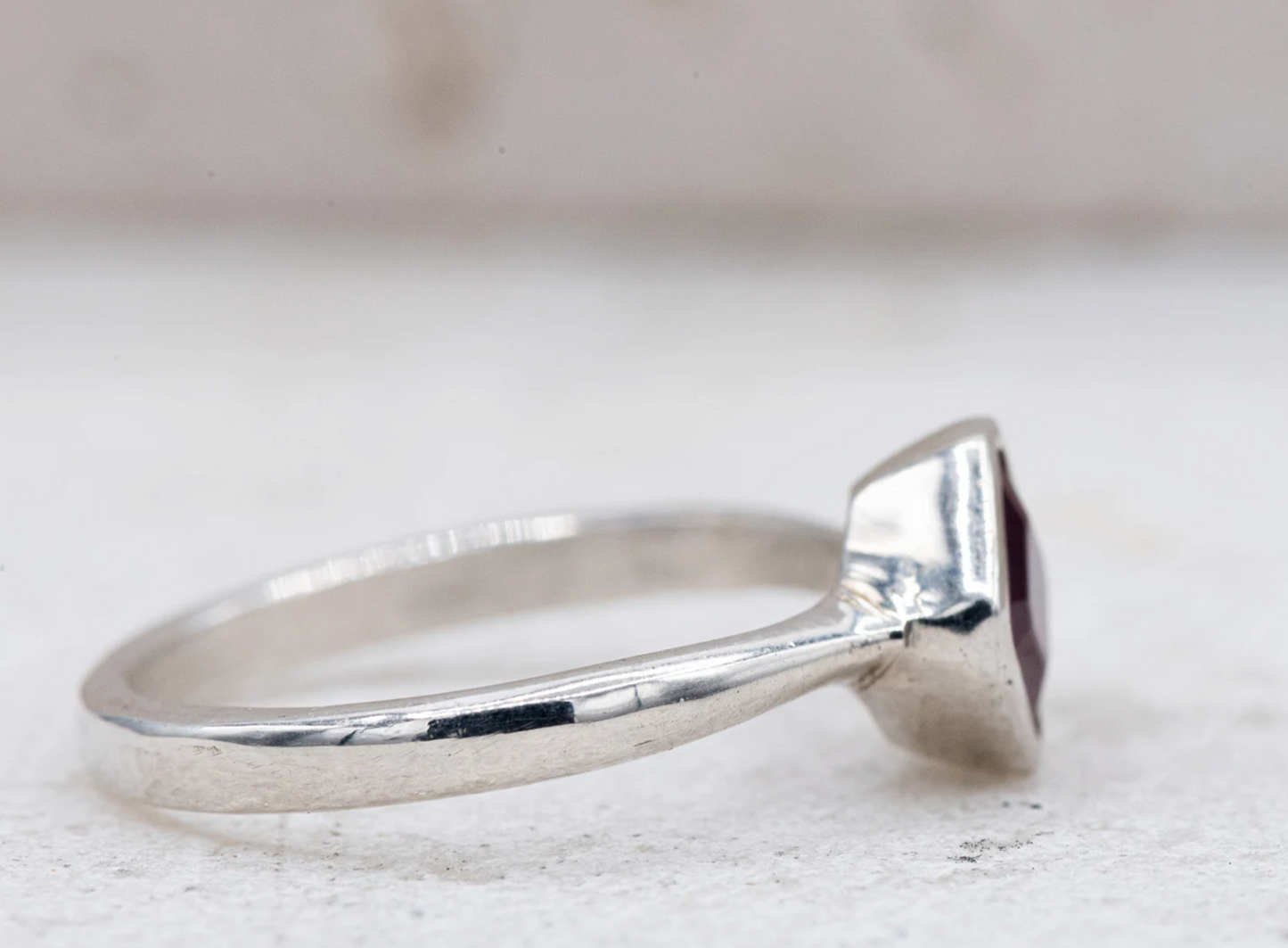 A handmade Asscher Cut Ruby Ring in Sterling Silver with a red stone.