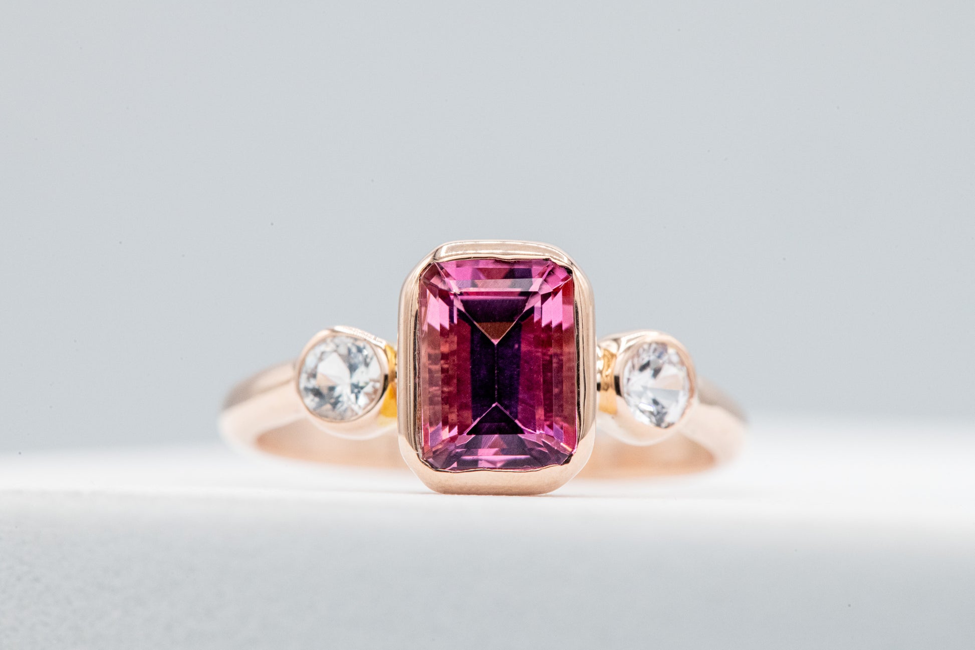 A handmade emerald cut Pink Tourmaline and diamond ring by Cassin Jewelry.
