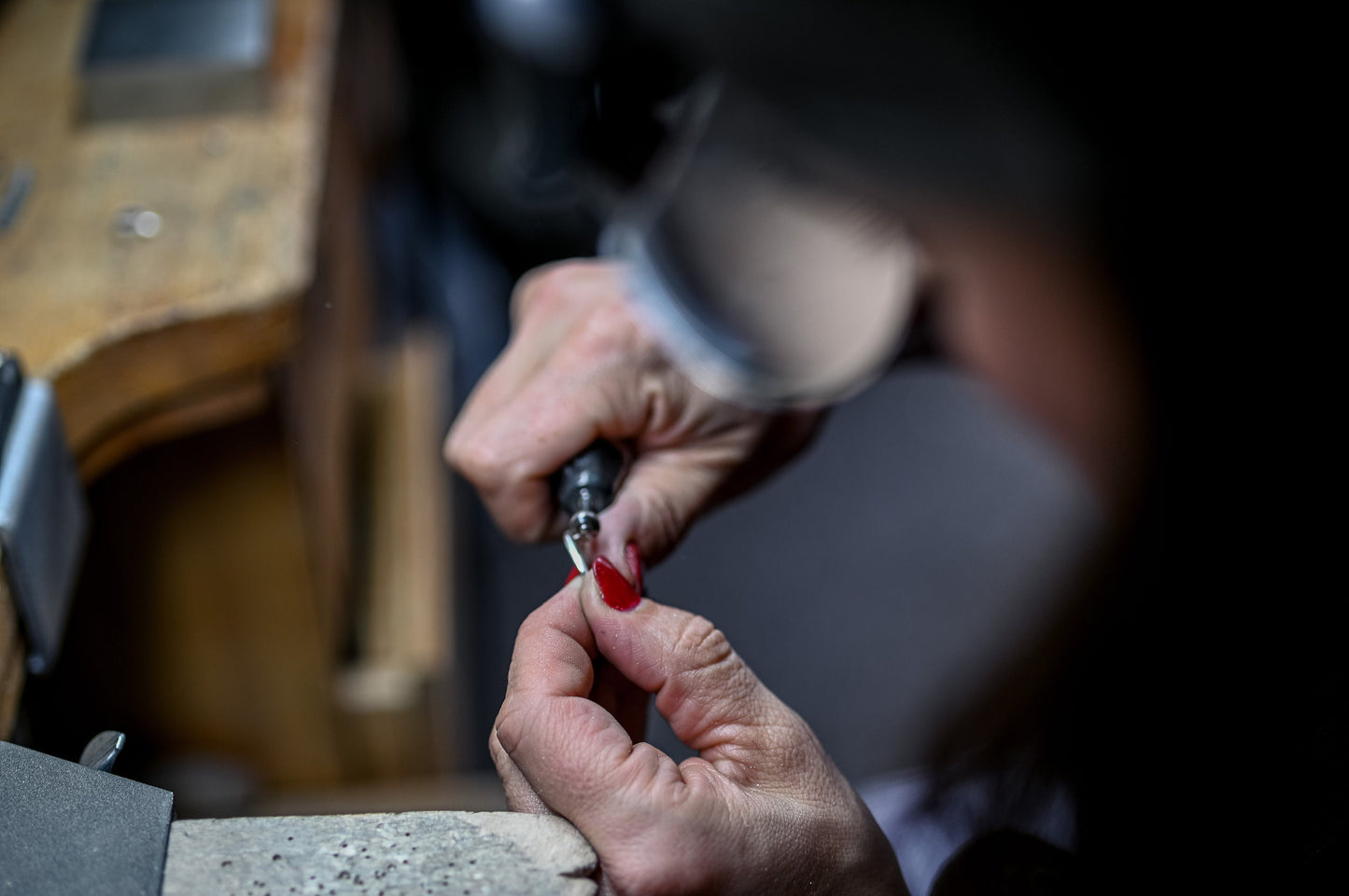 A person is working on handmade Peridot and Swiss Blue Topaz Gemstones Stacking Rings in Sterling Silver.