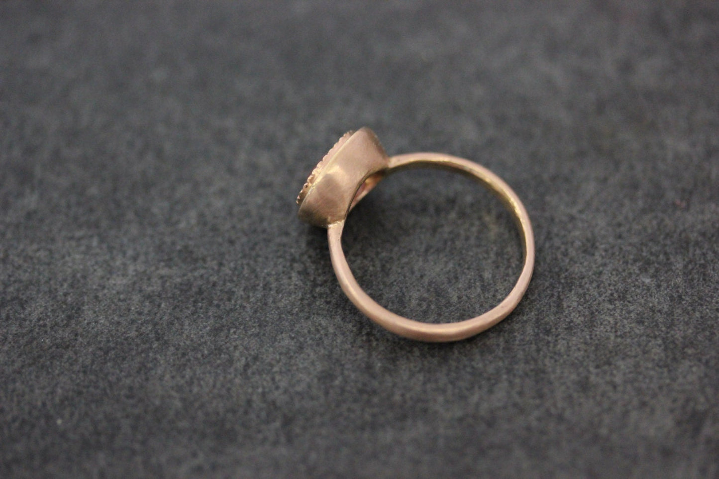 A handmade Oval Morganite 14k Rose Gold Engagement Ring with a diamond in the middle.