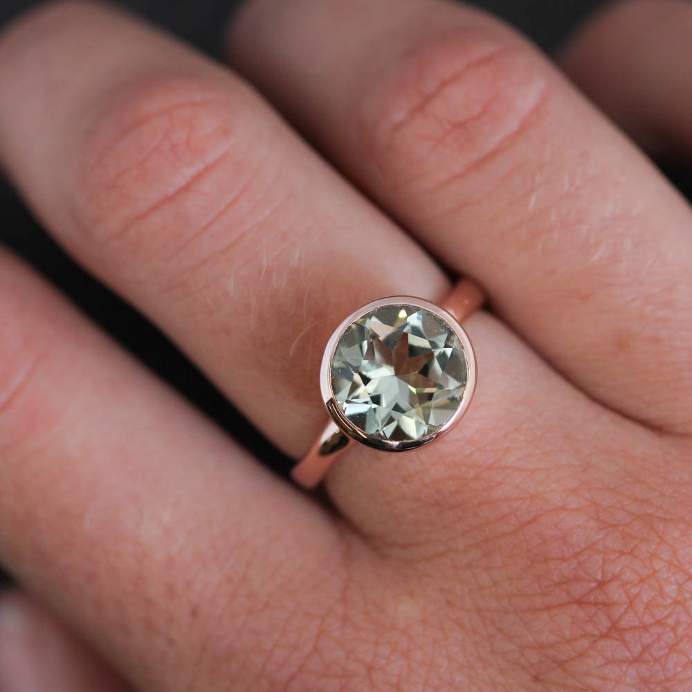 A Handmade Round Green Amethyst Ring in Rose Gold by Cassin Jewelry.