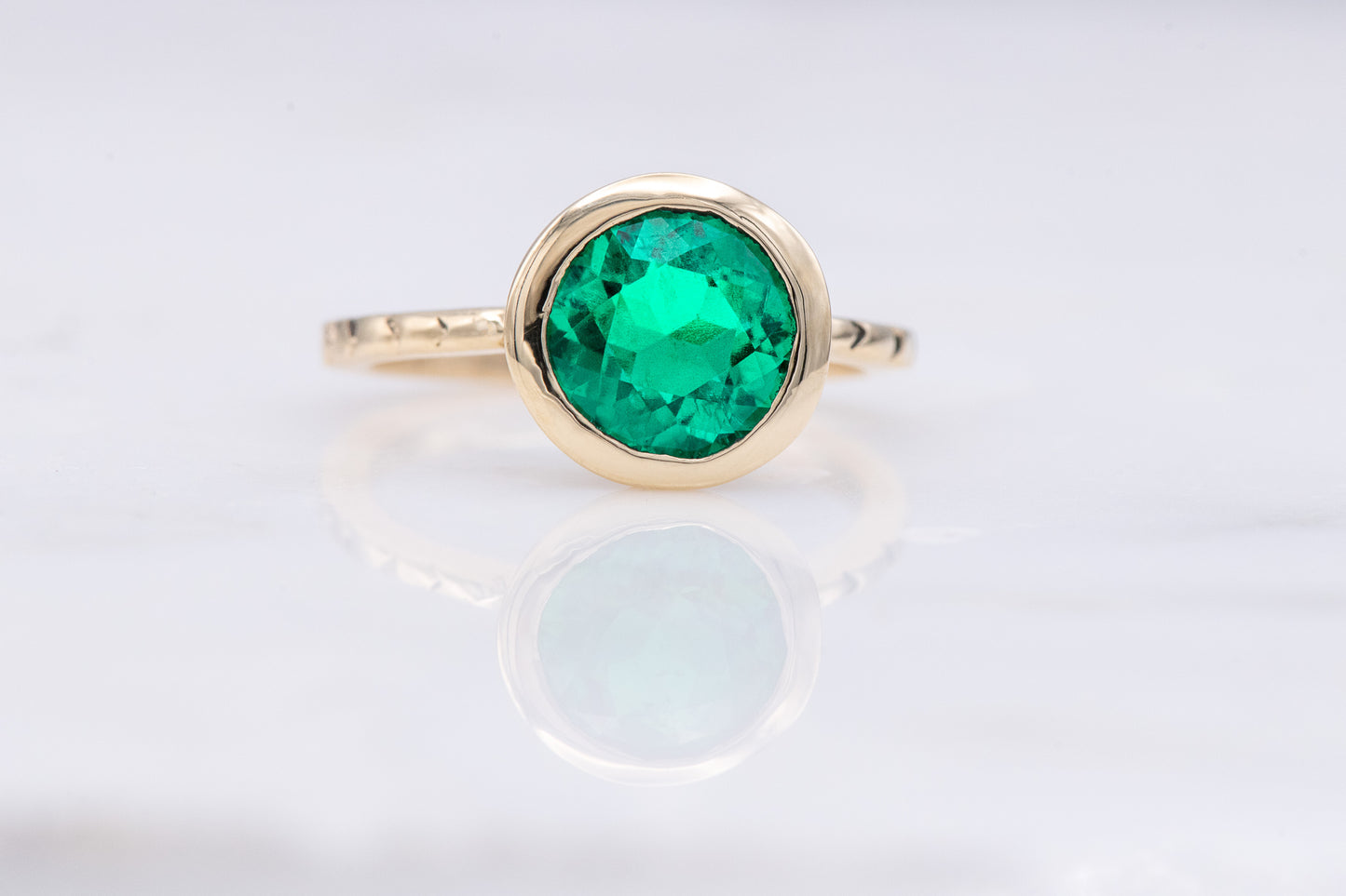 An Emerald and Yellow Gold Handmade Engagement Ring.
