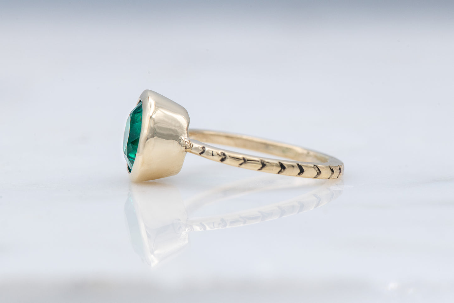 A Handmade Emerald and Yellow Gold Engagement Ring by Cassin Jewelry.