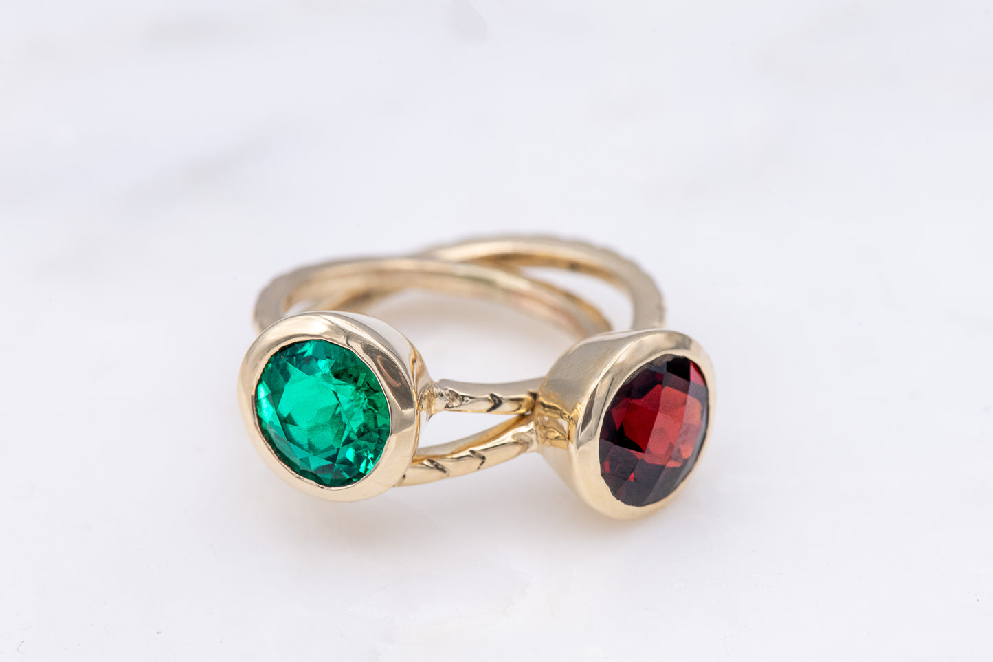 Handmade jewelry: A cassin emerald and yellow gold engagement ring with green and red stones.