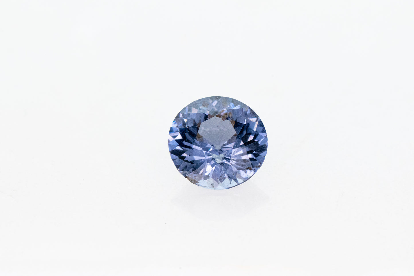 A handmade Round Blue Spinel on a white background.