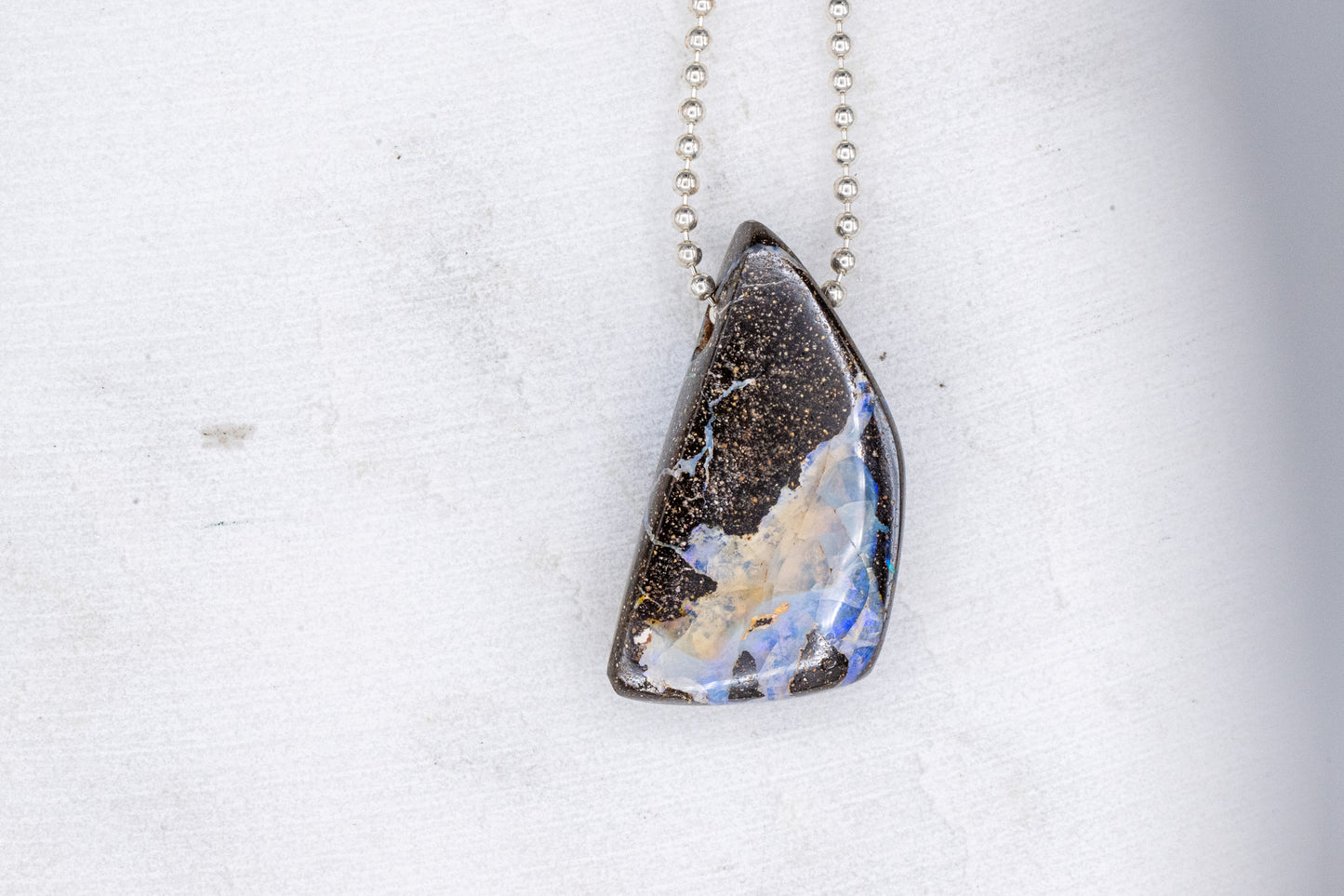 Handmade Australian Opal Necklace with a blue and brown stone sold by Cassin Jewelry.