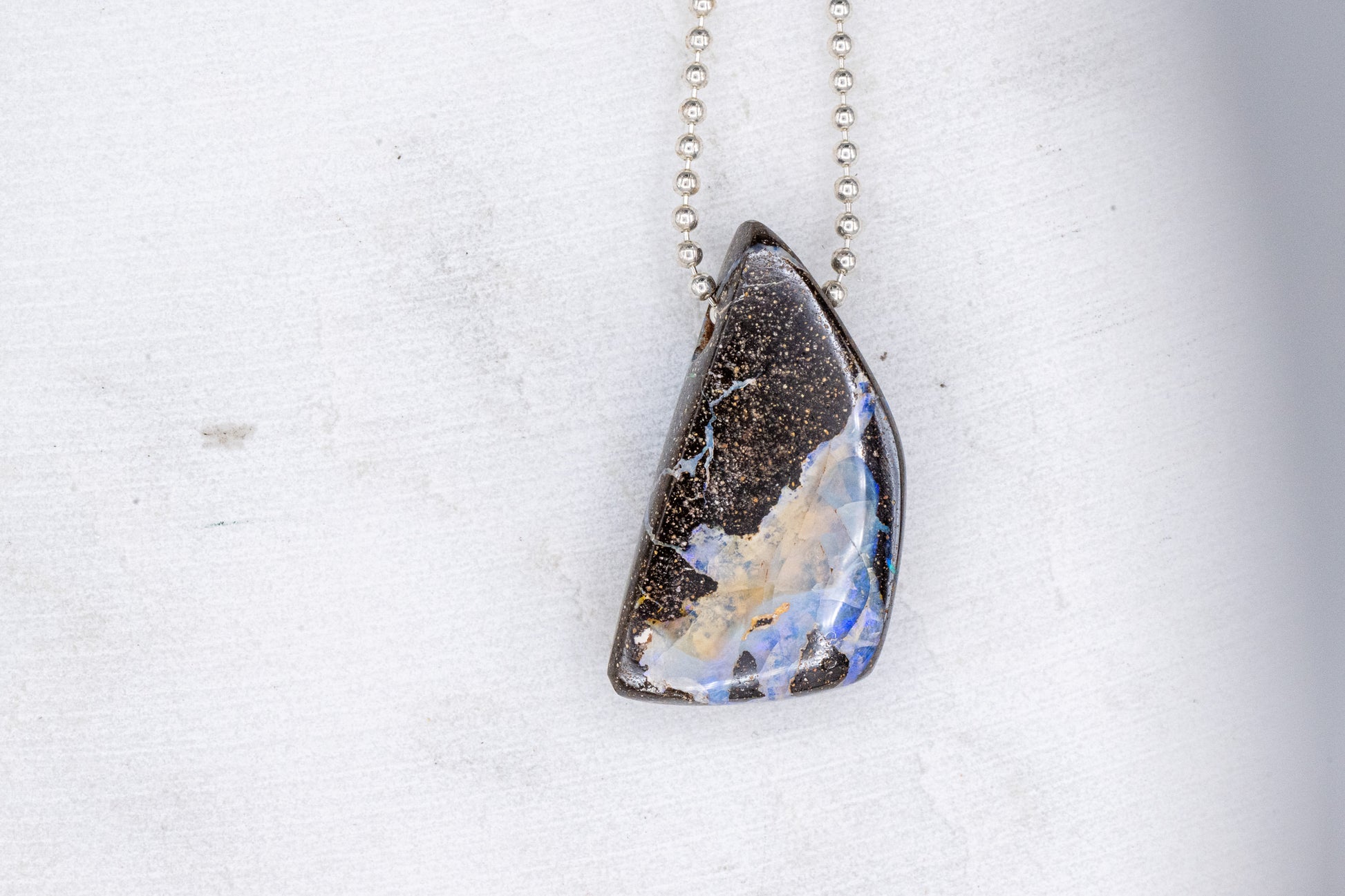 Handmade Australian Opal Necklace with a blue and brown stone sold by Cassin Jewelry.