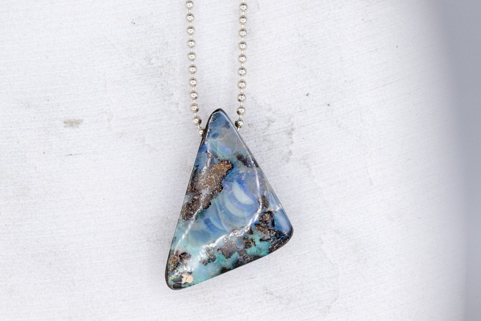 One of a kind handmade Australian Opal Necklace with a blue stone from Cassin Jewelry.