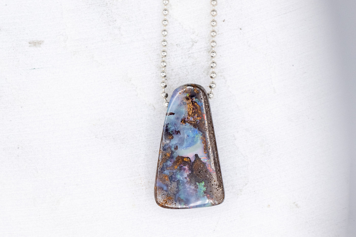 A One of a kind Australian Opal Necklace with an opal pendant on it, handmade by Cassin Jewelry.