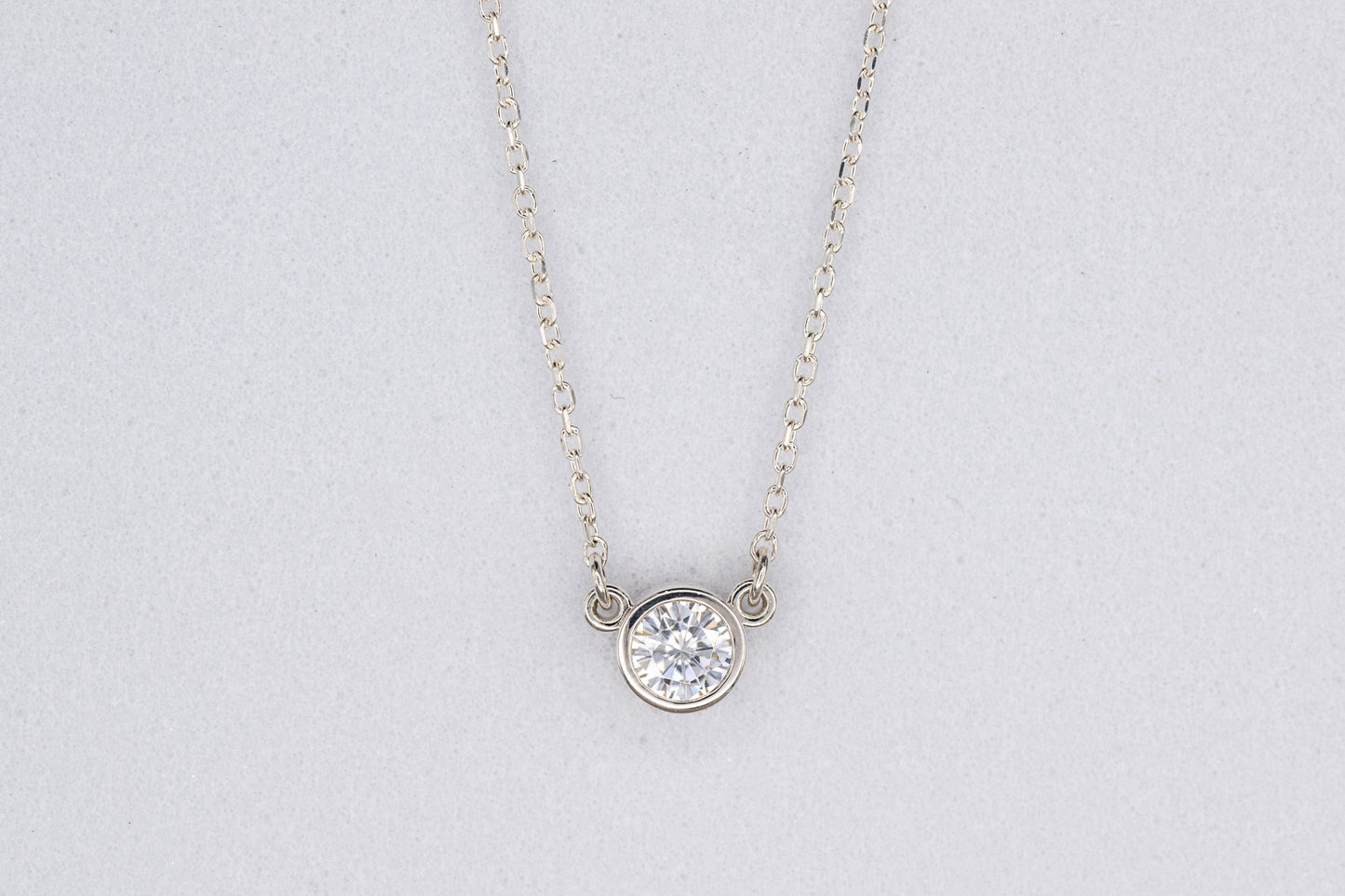 A handmade Moissanite Sterling Silver Necklace with a diamond focal point.