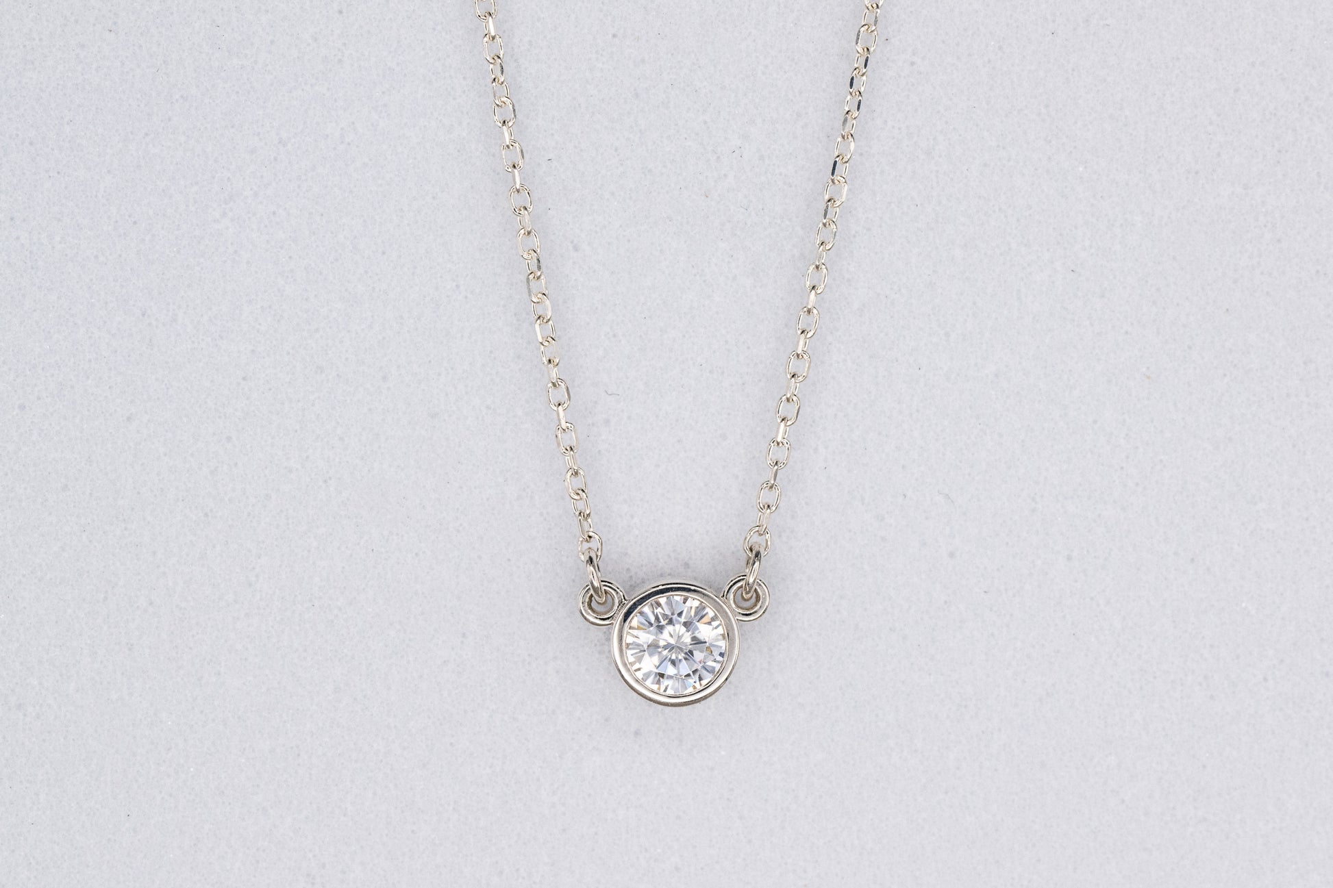 A handmade Moissanite Sterling Silver Necklace with a diamond focal point.