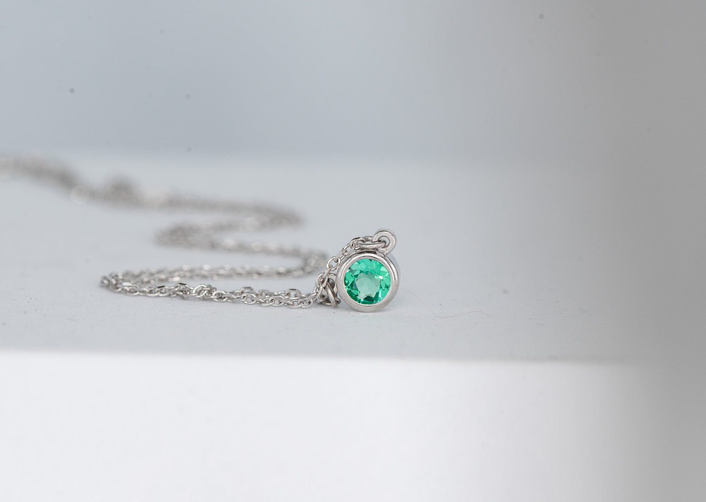 Emerald and White Gold Round Bezel Solitaire Necklace