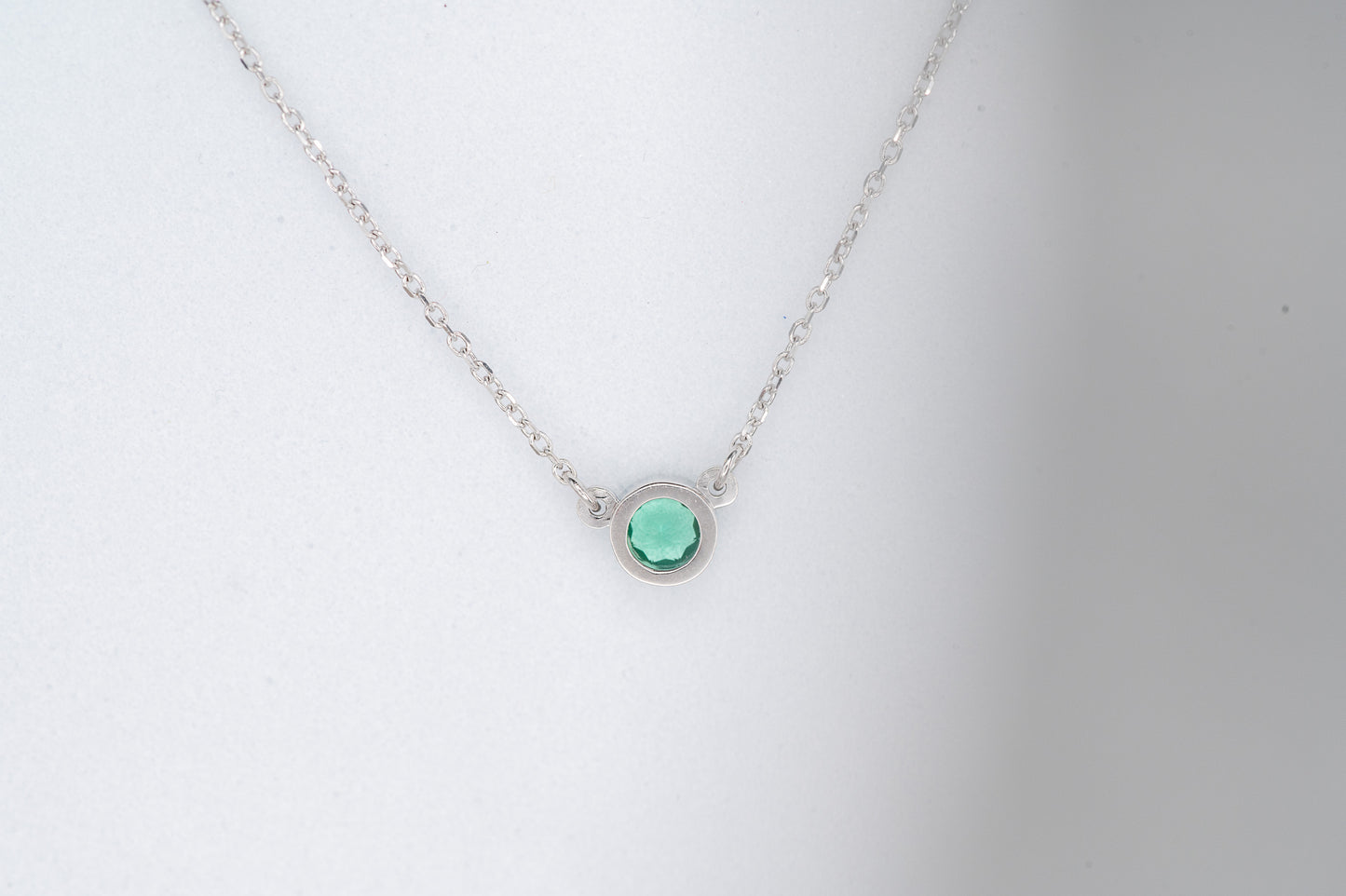Emerald and White Gold Round Bezel Solitaire Necklace