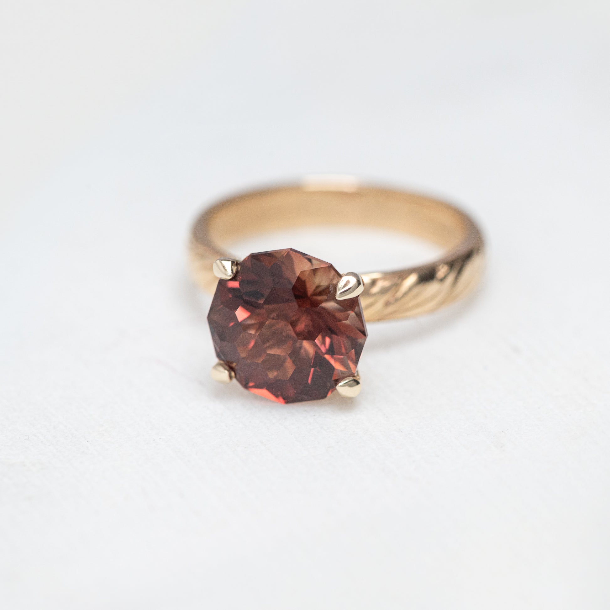 A gold ring with an intricate band design features a large, round, faceted reddish-brown gemstone: One of A Kind Custom Handcrafted Oregon Sunstone Ring in 14k Yellow Gold Size 7.