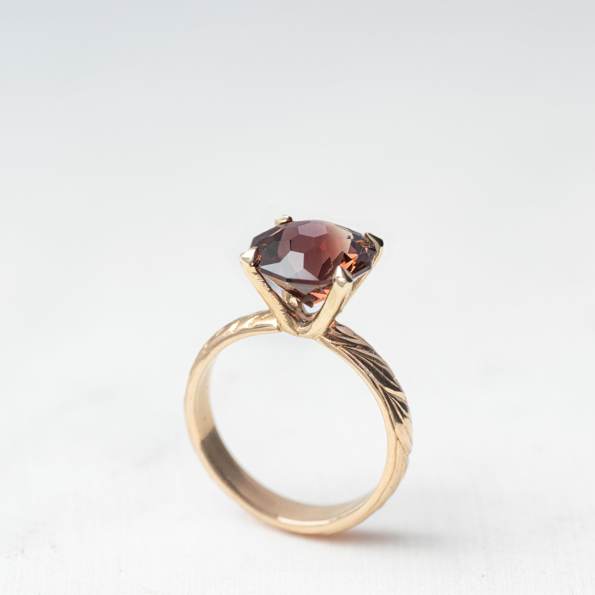 A One of A Kind Custom Handcrafted Oregon Sunstone Ring in 14k Yellow Gold Size 7 with a large red gemstone set in a prong setting, featuring an engraved band.