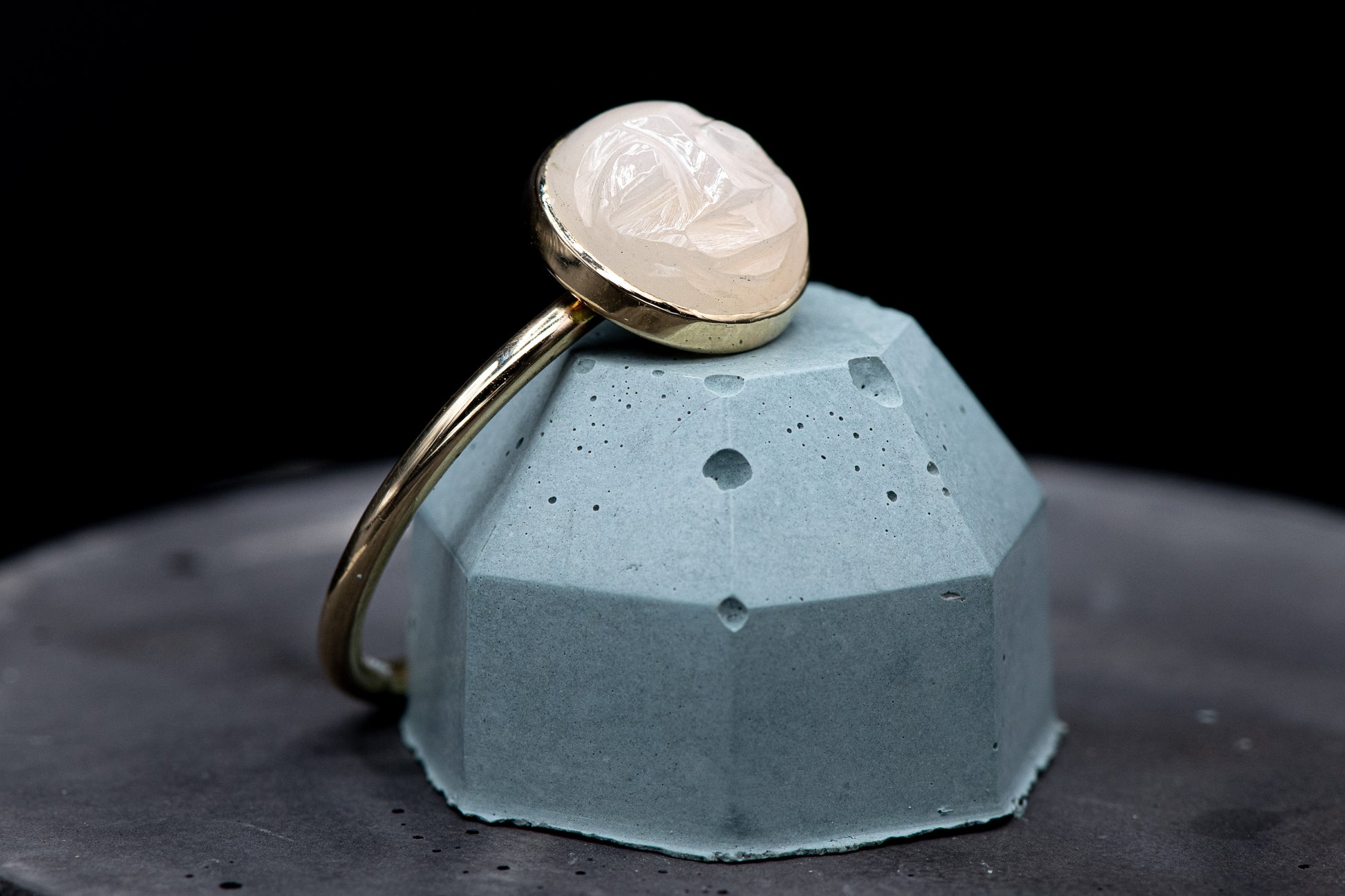 A handmade White Moonstone Face Ring in Recycled 14k Yellow Gold with a white stone on top by Cassin Jewelry.