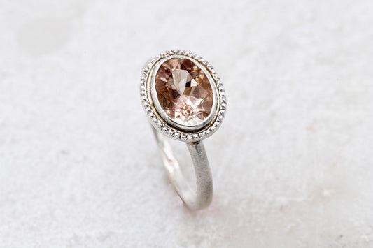 A handmade Oval Oregon Sunstone Ring in Sterling Silver with a morganite stone by Cassin Jewelry.