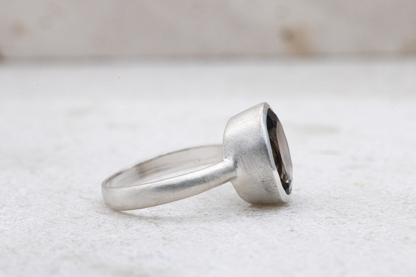 A Handmade Solitaire Smoky Quartz Ring with a smoky quartz stone.