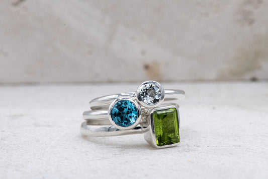 Handmade Sterling Silver Stacking Rings with Peridot and Swiss Blue Topaz Gemstones by Cassin Jewelry.