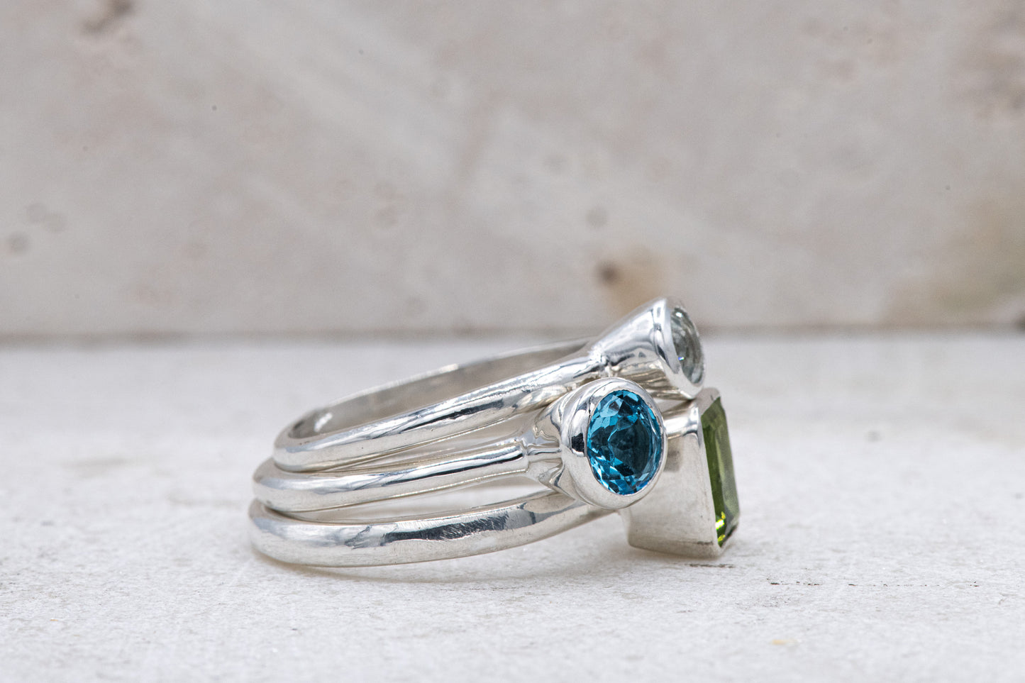 A Peridot and Swiss Blue Topaz Gemstones Stacking Rings in Sterling Silver, handmade by Cassin Jewelry.