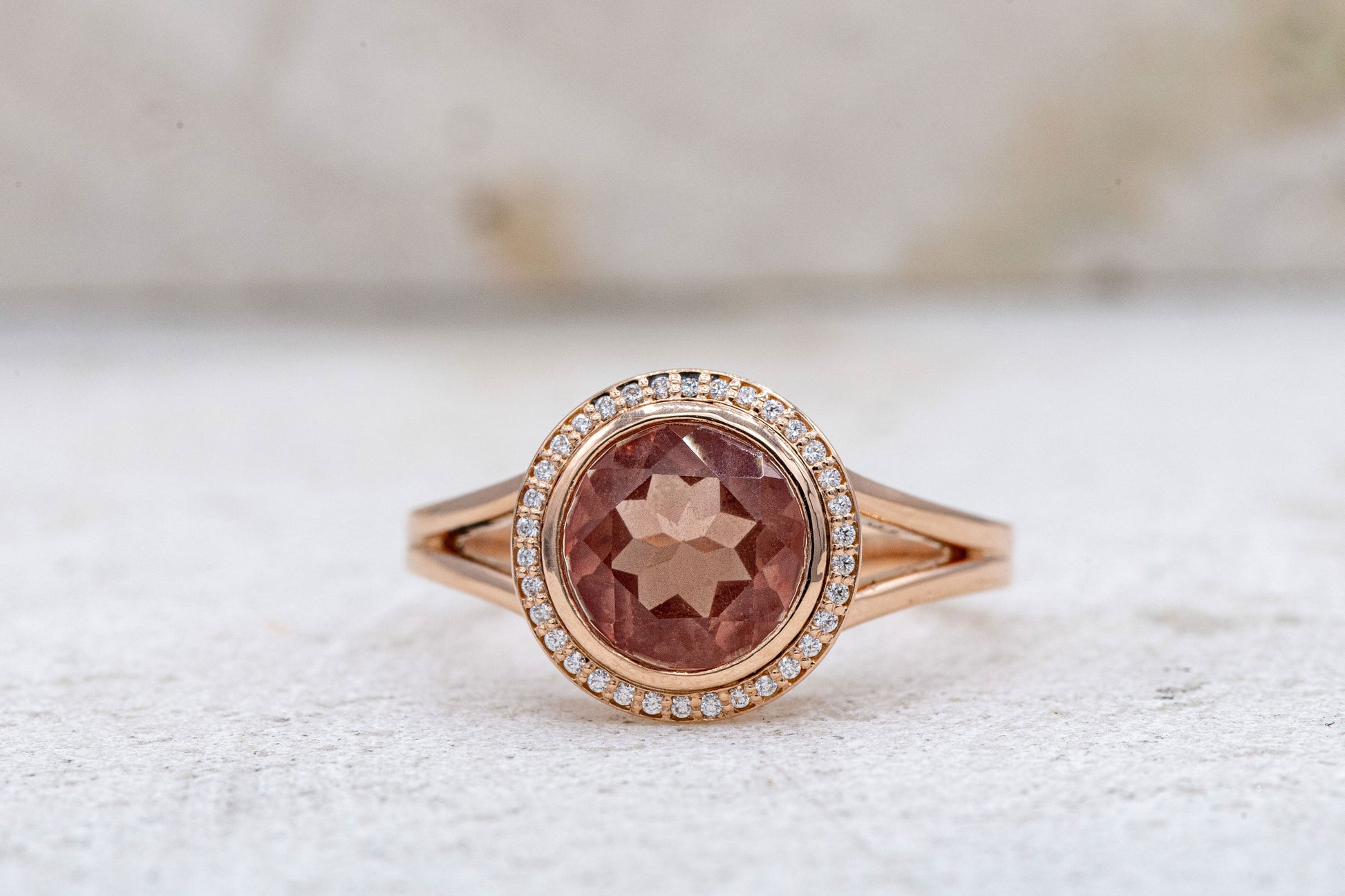 A Cassin handmade Oregon Sunstone Diamond Halo Ring with a morganite stone and diamonds.