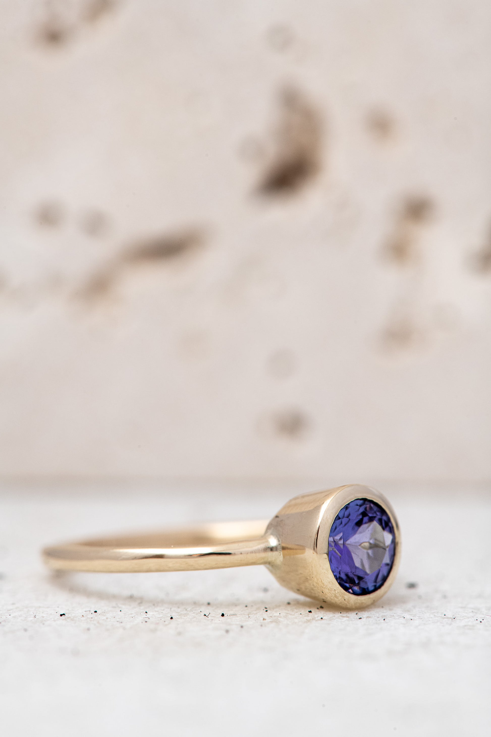 A yellow gold Round Tanzanite Solitaire Ring handmade by Cassin Jewelry.