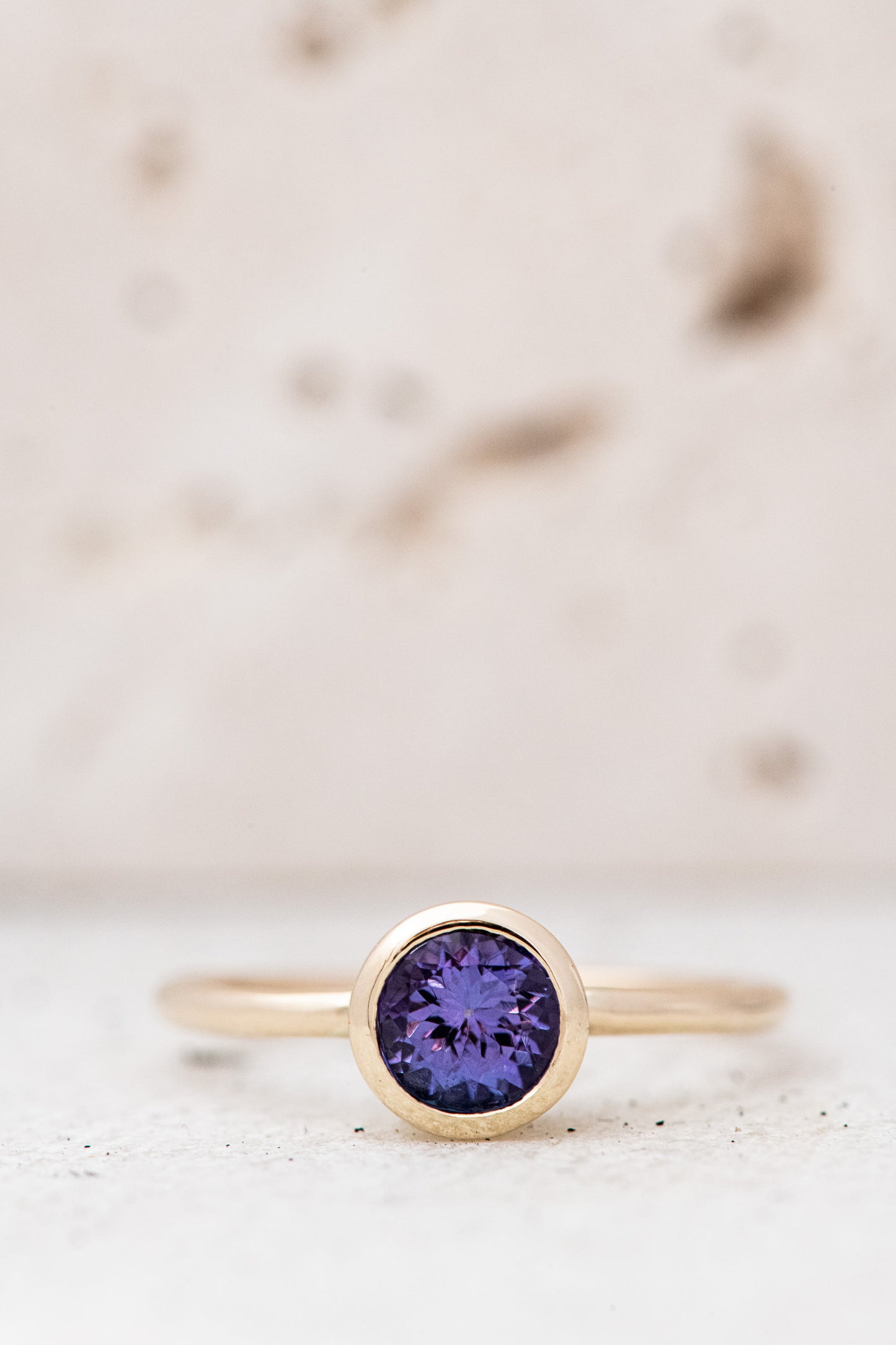 A handmade Tanzanite Solitaire Ring with a purple sapphire stone.