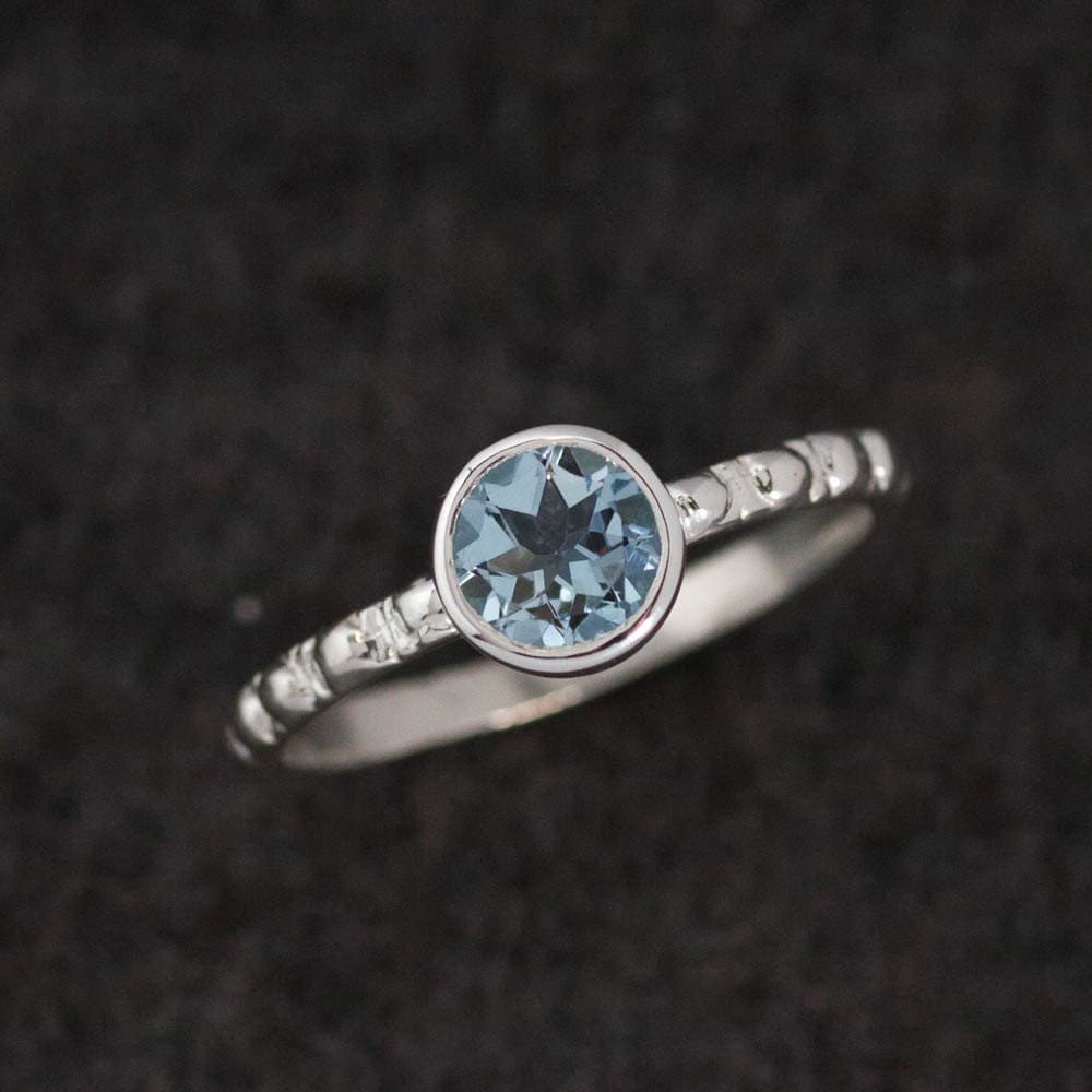 Handmade aquamarine ring with a blue topaz stone.
