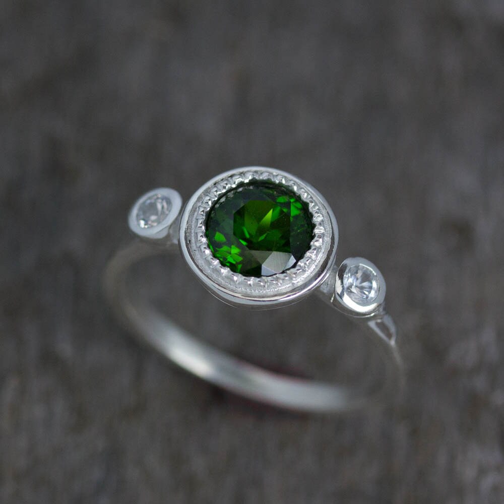 A handmade Chrome Diopside ring with an emerald stone and diamonds.