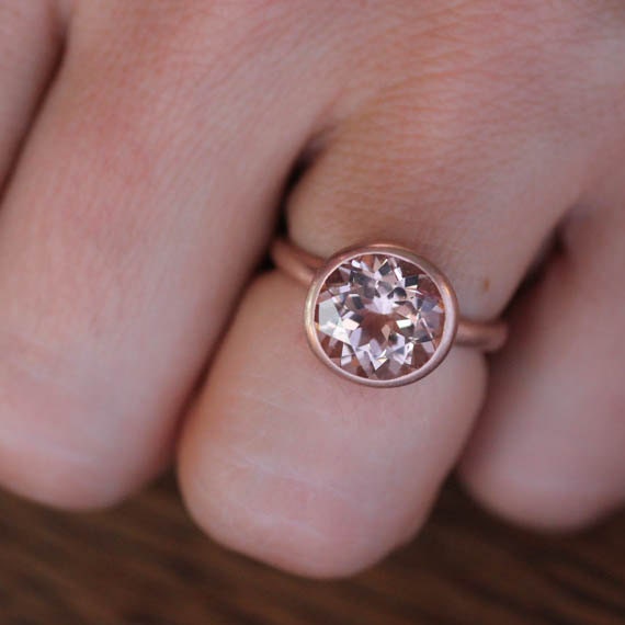 A handmade engagement ring with a 10mm Round Morganite Rose Gold Gemstone from Cassin Jewelry.