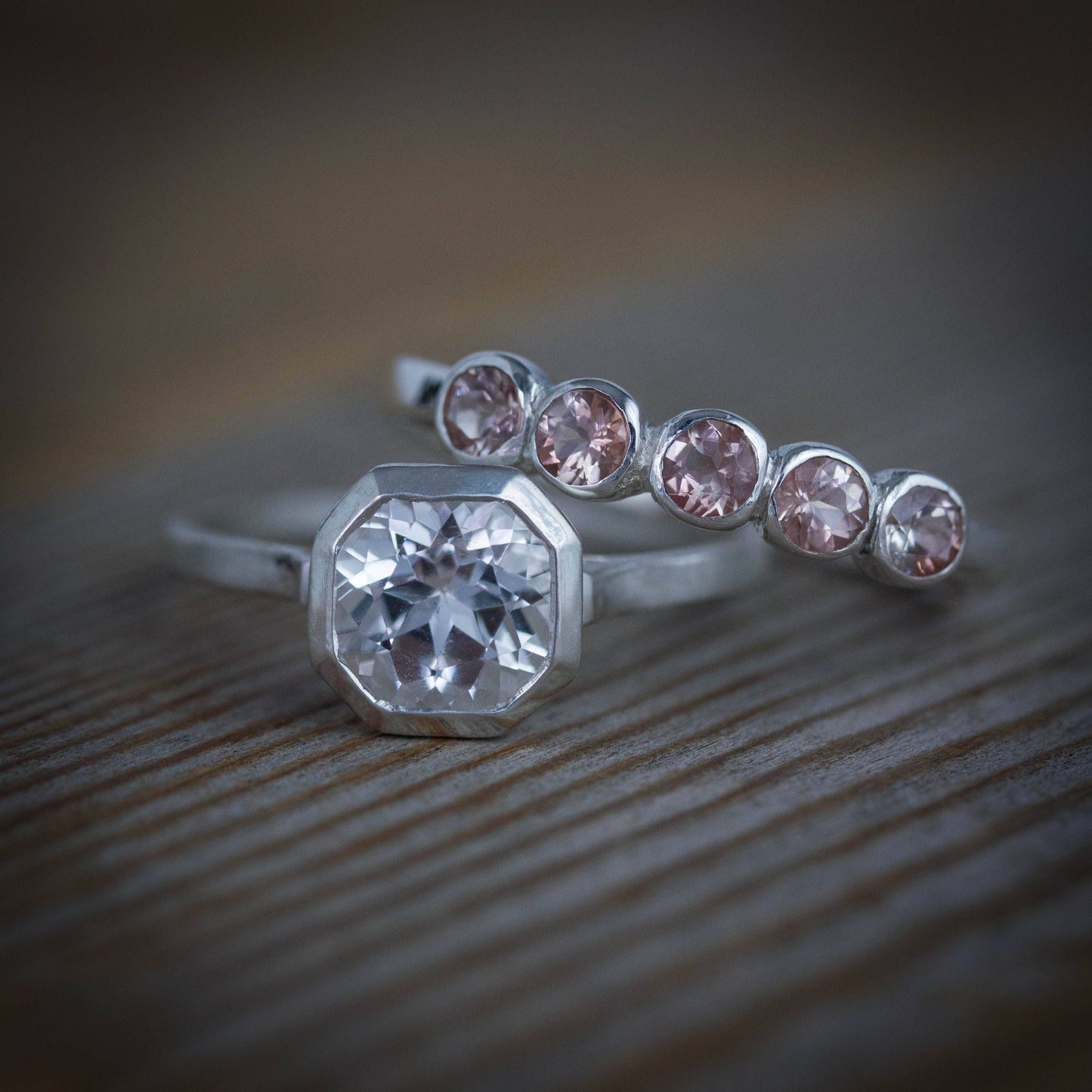 A handmade Oregon Sunstone band ring with pink sapphires by Cassin Jewelry.