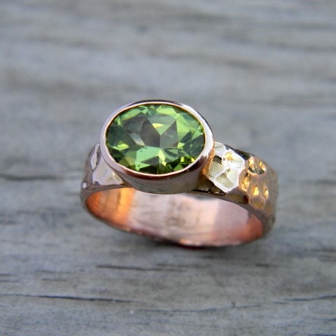 A Peridot Ring In Rose Gold August Birthstone Handmade Jewelry with a green peridot stone.
