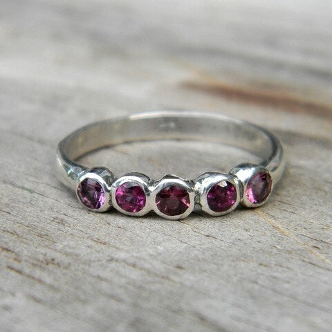 A handmade sterling silver Pink Garnet Anniversary Band with pink tourmaline stones by Cassin Jewelry.