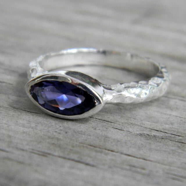 A handmade Iolite Slice Ring in Hammered Argentium Silver with a sapphire stone by Cassin Jewelry.