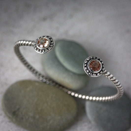 A Peach Oregon Sunstone Bracelet with two stones, handmade by Cassin Jewelry.