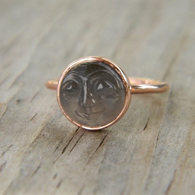 A handmade Cassin jewelry with a Man in the Moon Rose Gold Black Moonstone Ring featuring a face.