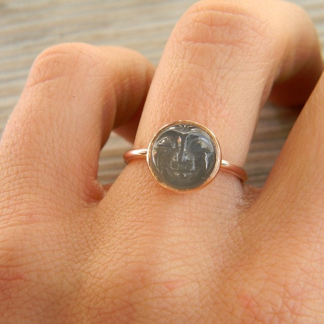 A person wearing a handmade Man in the Moon Rose Gold Black Moonstone Ring.