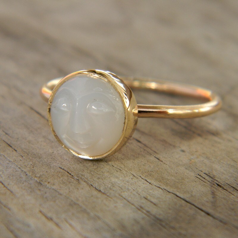 A handmade White Moonstone Face Ring in Recycled 14k Yellow Gold with a white stone on it by Cassin Jewelry.