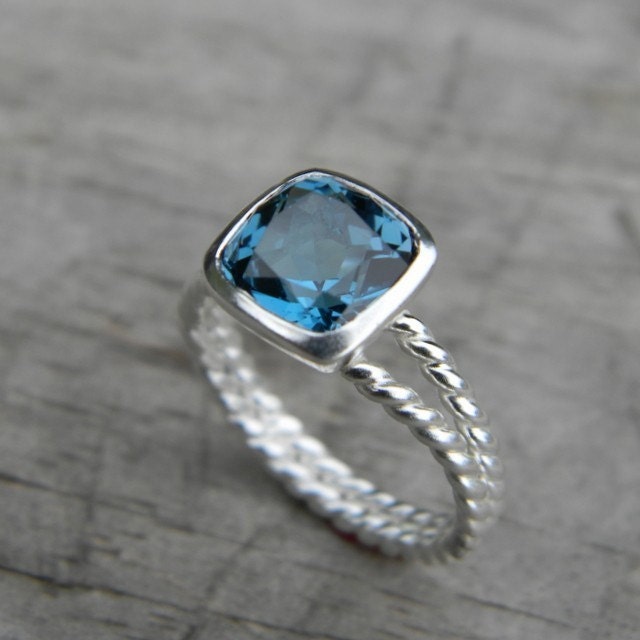 A Handmade London Blue Topaz Split Shank Ring with a blue topaz stone by Cassin Jewelry.