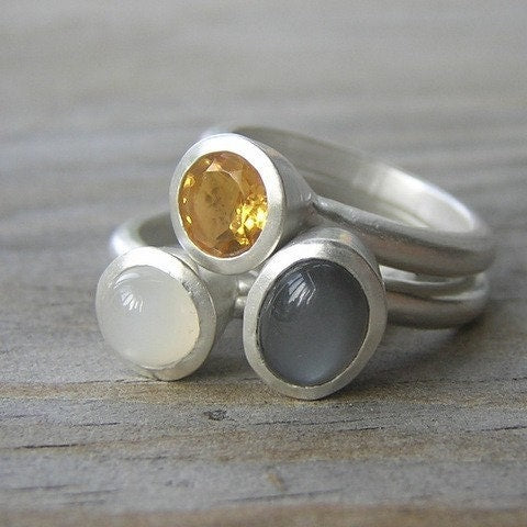 A handmade Moonstone Stacking Ring Set with a yellow and white stone by Cassin Jewelry.