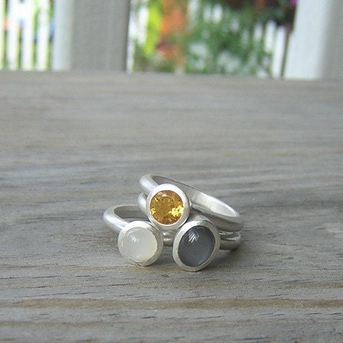 A handmade Moonstone Stacking Ring Set with a yellow and white stone by Cassin Jewelry.