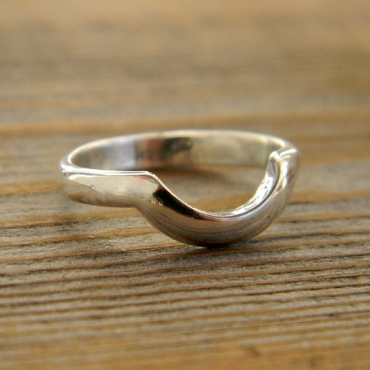 A handmade Cassin Jewelry Wrap Band wedding band in Argentium Silver with a curved shape.