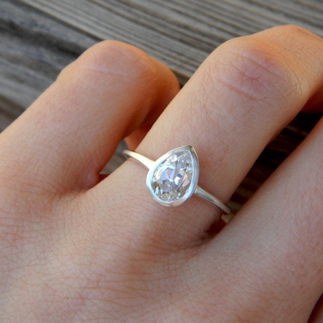 A handmade engagement ring with a Pear White Topaz from Cassin Jewelry.