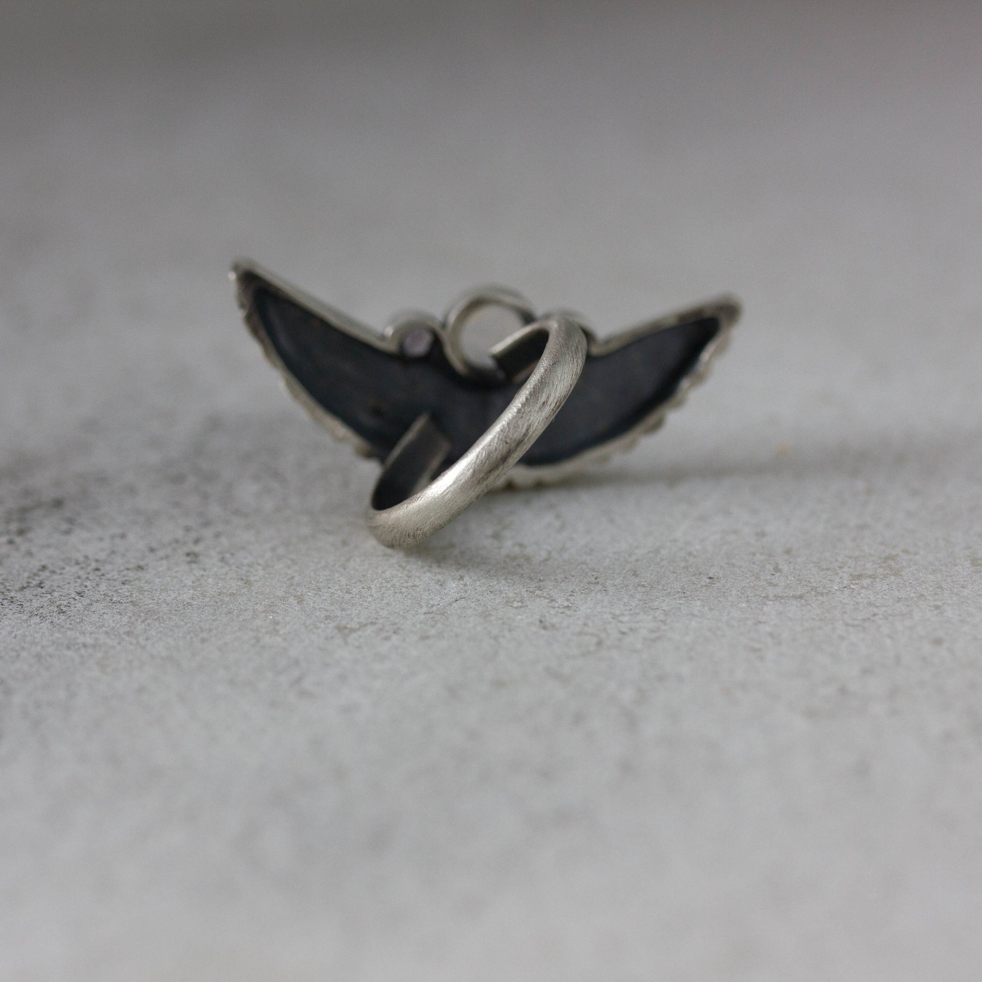 Handmade Silver Wing Statement Ring with a black wing, by Cassin Jewelry.
