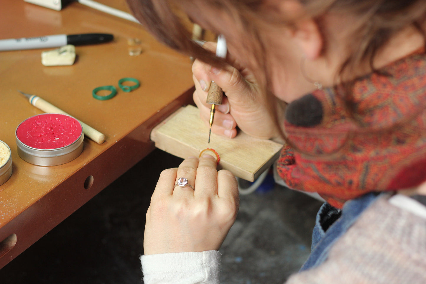 A woman is crafting a handmade Silver Wing Statement Ring for Cassin Jewelry.