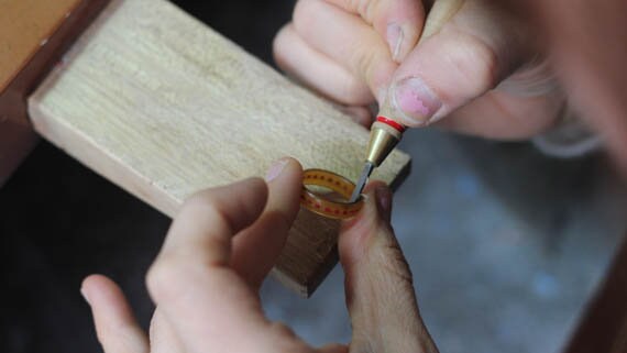 A person is working on a Handmade Rose De France Amethyst Ring.