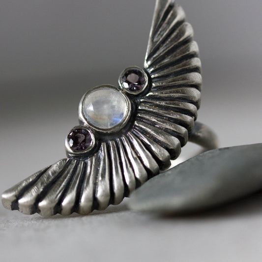 Handmade Cassin jewelry featuring a Silver Wing Statement Ring with a Silver Moonstone and Amethyst.